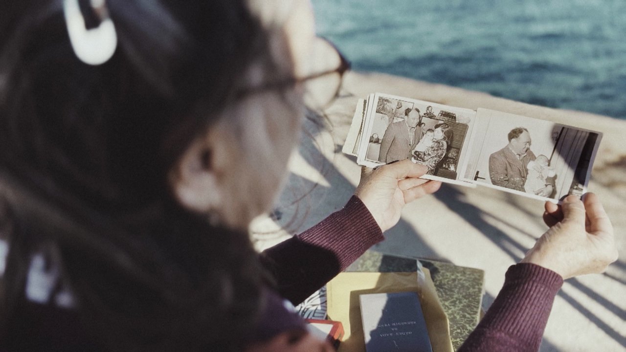 A woman holding family photographs